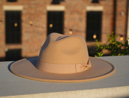 A light tan color fedora with a large brim,