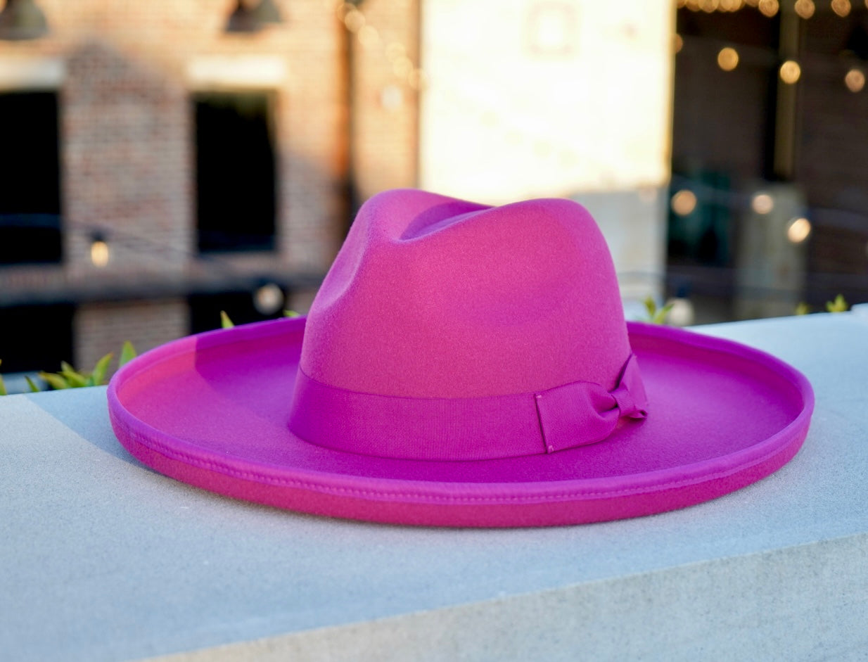 A picture of a hot pinl colored pencil rolled brim fedora hat.