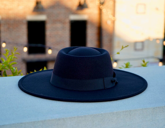 A picture of a black color bolero crown fedora hat with a headband.